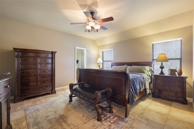 bedroom featuring ceiling fan, vaulted ceiling, and multiple windows