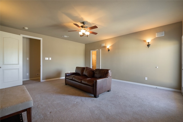 carpeted living room with ceiling fan