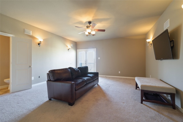 living room featuring light colored carpet and ceiling fan