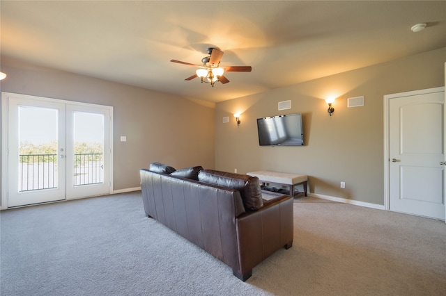 living room featuring french doors, ceiling fan, and light colored carpet