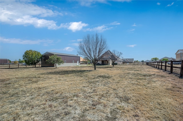 view of yard with a rural view and an outbuilding