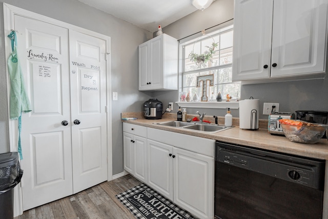 kitchen with white cabinetry, dishwasher, sink, and light wood-type flooring