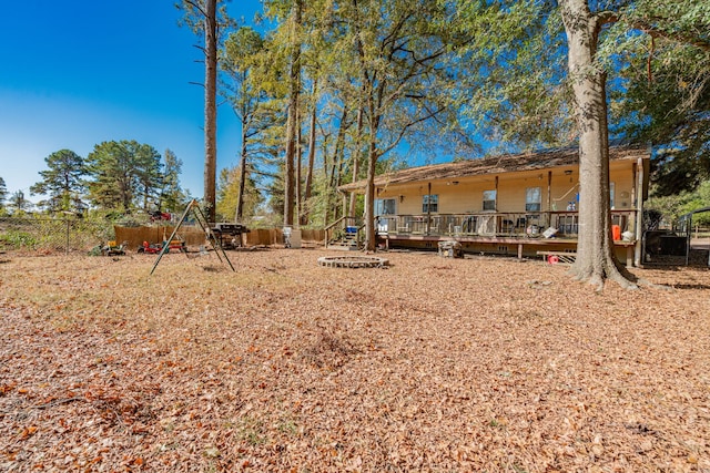 view of yard featuring a wooden deck and an outdoor fire pit