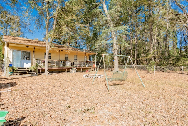 exterior space with a deck and a playground