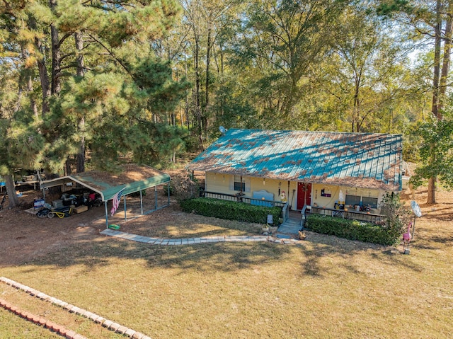 view of front of home with a carport, a porch, and a front lawn