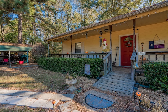 view of exterior entry featuring a porch