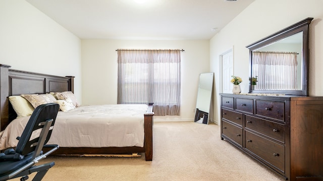 bedroom featuring multiple windows and light colored carpet