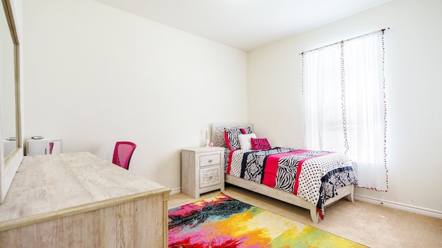 carpeted bedroom featuring multiple windows