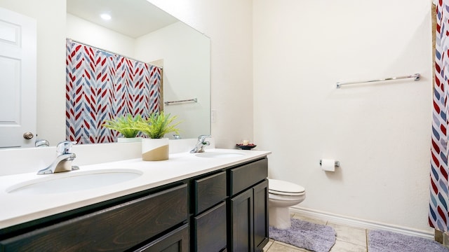 bathroom featuring vanity, curtained shower, toilet, and tile patterned floors