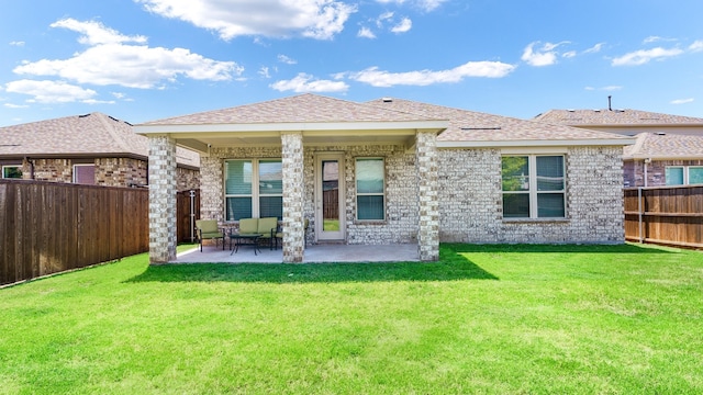 back of property featuring a patio and a lawn