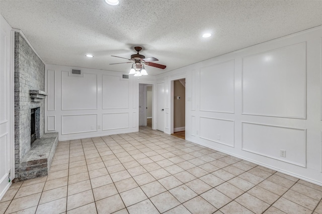 unfurnished living room featuring a textured ceiling, a fireplace, and ceiling fan