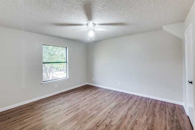 empty room with a textured ceiling, light hardwood / wood-style flooring, and ceiling fan