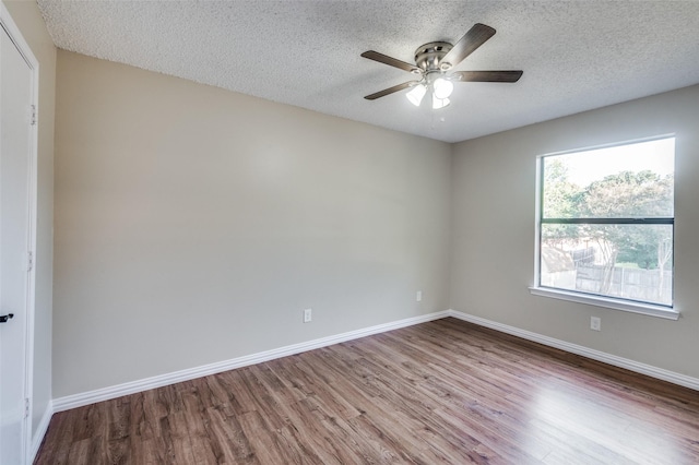 spare room featuring ceiling fan, hardwood / wood-style floors, and a textured ceiling