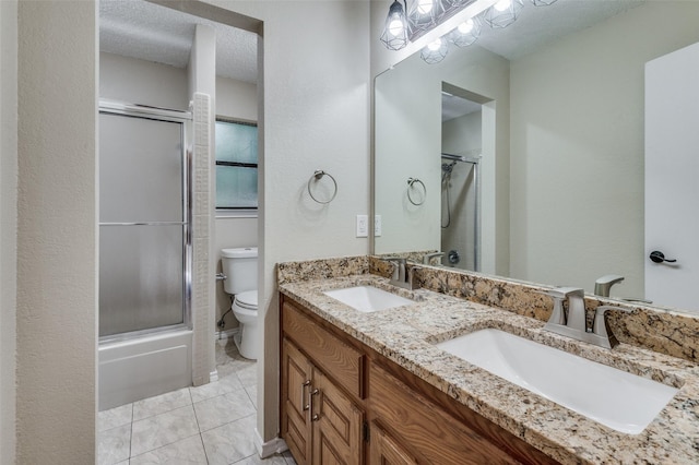 full bathroom featuring enclosed tub / shower combo, vanity, toilet, tile patterned floors, and a textured ceiling