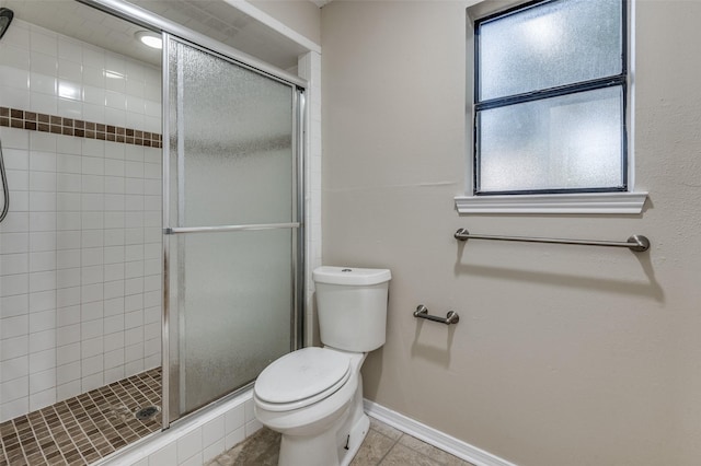 bathroom with walk in shower, tile patterned floors, and toilet