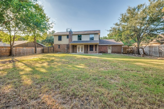 back of house featuring a yard