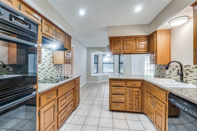 kitchen featuring sink, light tile patterned floors, black appliances, a textured ceiling, and kitchen peninsula