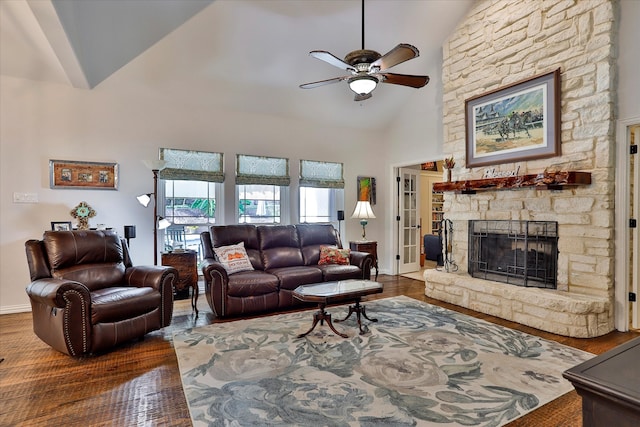 living room with dark hardwood / wood-style floors, high vaulted ceiling, a fireplace, and ceiling fan