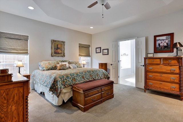 carpeted bedroom with multiple windows and ceiling fan