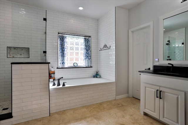 bathroom with vanity, tile patterned floors, and shower with separate bathtub