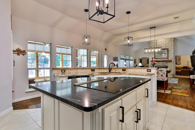 kitchen featuring a large island, lofted ceiling, and light wood-type flooring