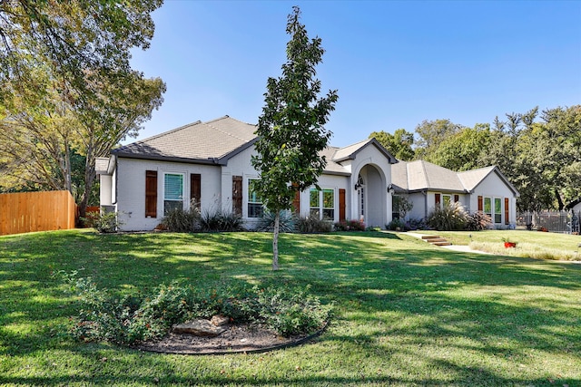 ranch-style home with a front yard