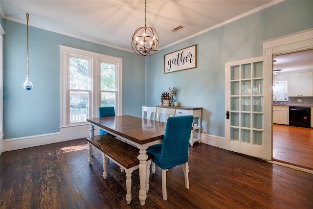 dining space with crown molding, an inviting chandelier, and dark hardwood / wood-style flooring