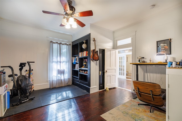 interior space with ornamental molding, dark hardwood / wood-style floors, a healthy amount of sunlight, and ceiling fan