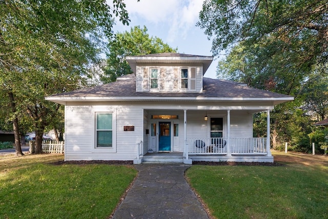 view of front of home featuring a front lawn and covered porch