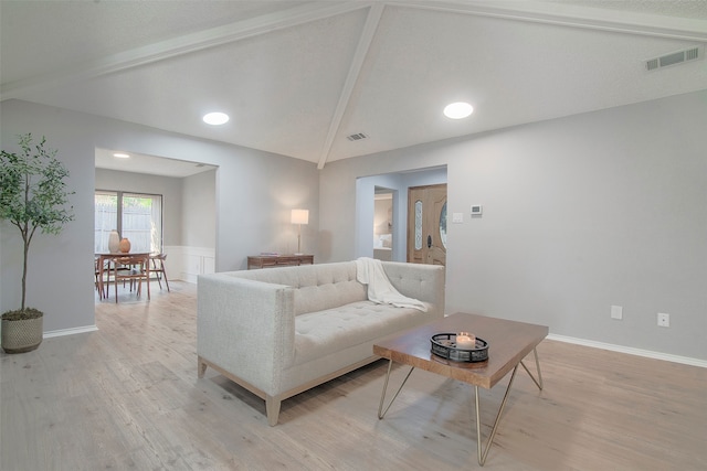 living room with lofted ceiling and light hardwood / wood-style flooring