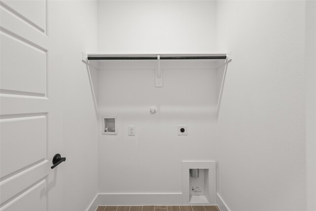 clothes washing area featuring hookup for a gas dryer, wood-type flooring, washer hookup, and electric dryer hookup