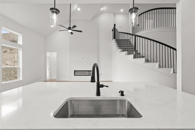 kitchen featuring hanging light fixtures, sink, high vaulted ceiling, and a wealth of natural light