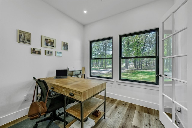 office with light hardwood / wood-style flooring