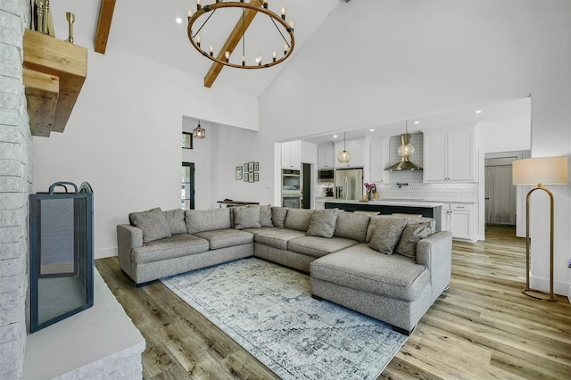 827 Kiowa Dr W, Gainesville, TX 76240 - living room featuring high vaulted ceiling, a chandelier, light wood-type flooring, beamed ceiling, and recessed lighting