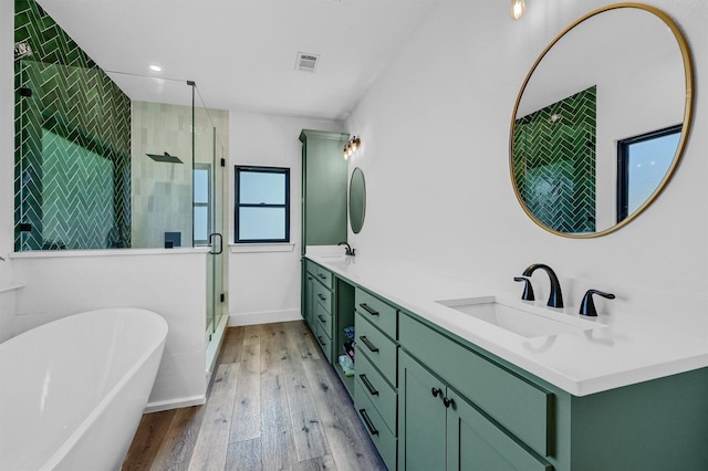 bathroom with vanity, wood-type flooring, and shower with separate bathtub