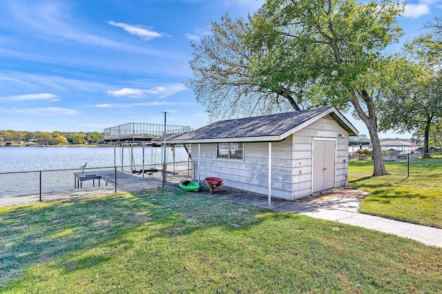 exterior space with a water view and a lawn