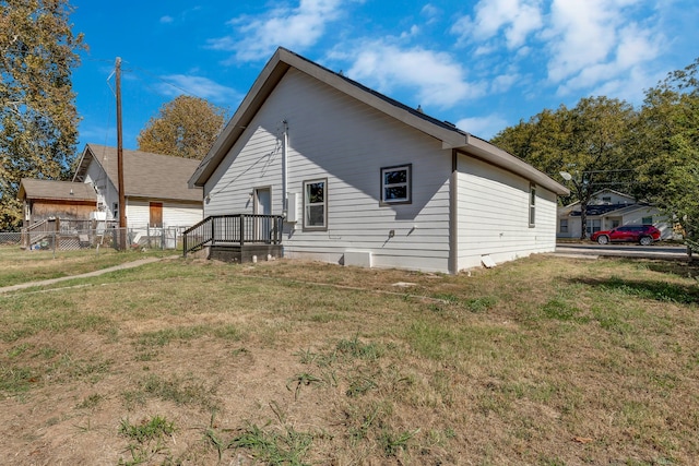 view of side of property with a yard