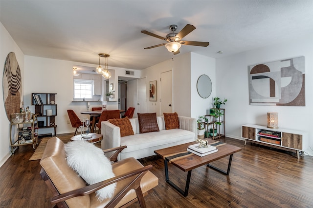 living room featuring ceiling fan and dark hardwood / wood-style flooring