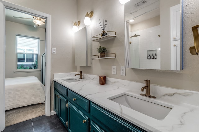 bathroom featuring vanity, a tile shower, and tile patterned floors