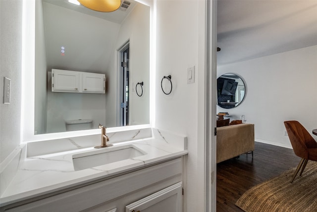 bathroom featuring toilet, hardwood / wood-style flooring, and vanity