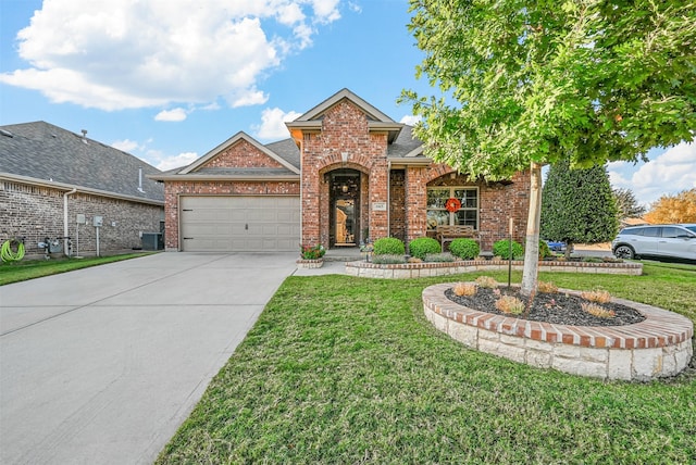 view of front of property featuring central AC unit, a front yard, and a garage