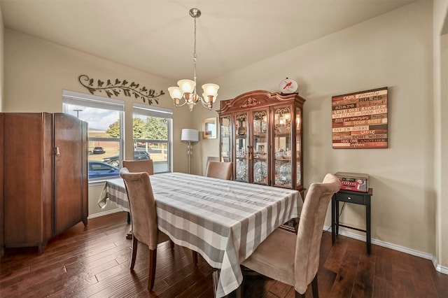 dining room featuring dark hardwood / wood-style flooring and an inviting chandelier