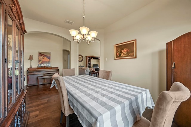 dining space featuring dark hardwood / wood-style flooring and a notable chandelier