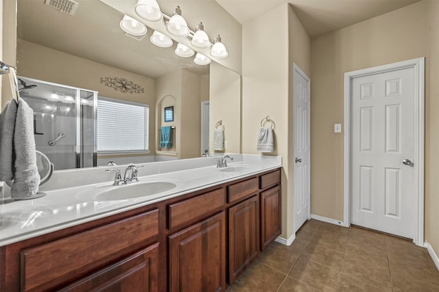 bathroom featuring tile patterned flooring, vanity, and an enclosed shower