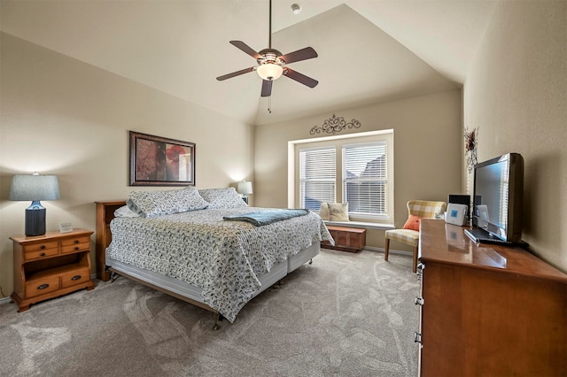 carpeted bedroom with ceiling fan and vaulted ceiling