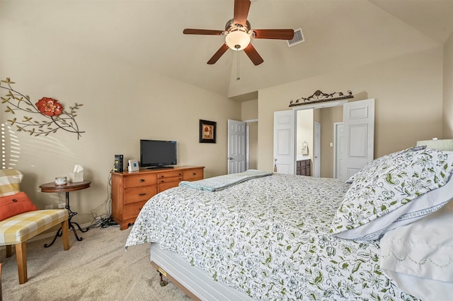 carpeted bedroom featuring connected bathroom, vaulted ceiling, and ceiling fan