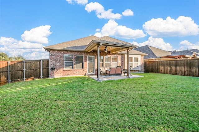 rear view of house with a lawn, a patio area, and ceiling fan