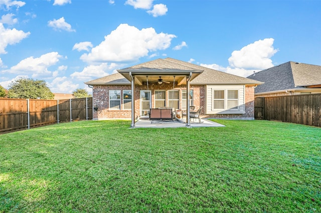 rear view of property with a lawn, ceiling fan, and a patio area