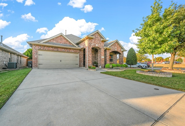 view of front of house with a front yard, a garage, and cooling unit