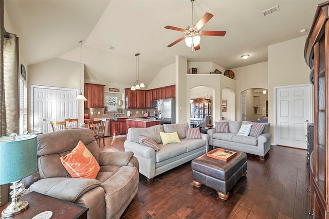 living room featuring a wealth of natural light, dark hardwood / wood-style floors, and ceiling fan